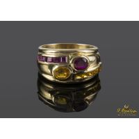 Sortija realizada en oro amarillo y motivos con topacios y rubíes.