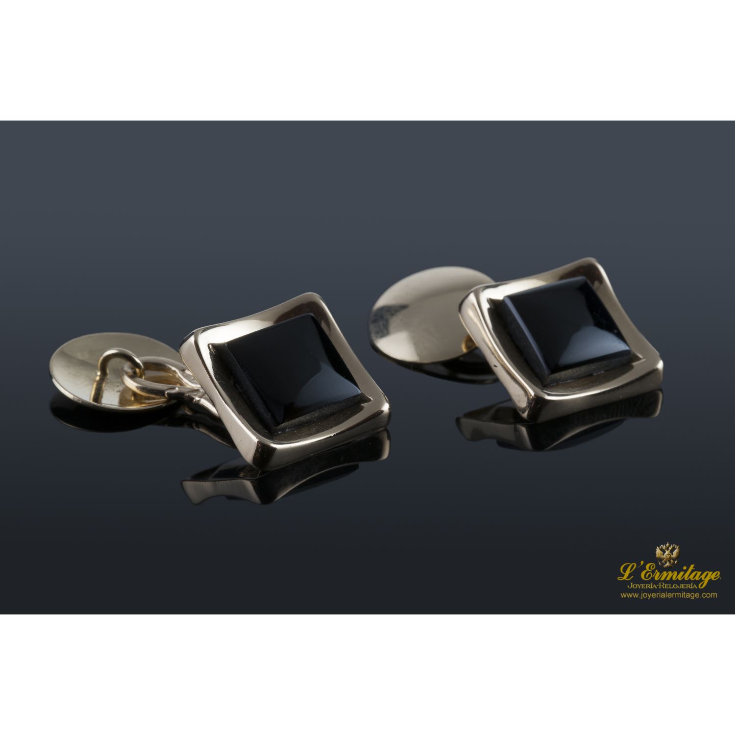 Gemelos realizados en oro amarillo y motivos con onix