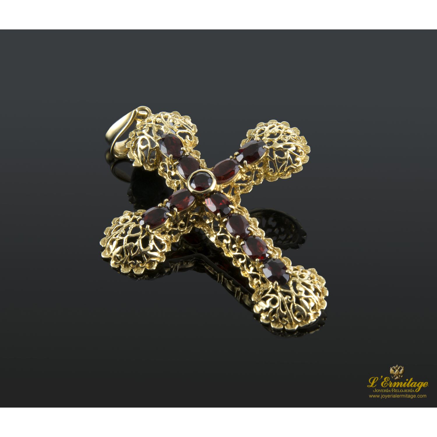 Colgante en forma de cruz en oro amarillo con granates.