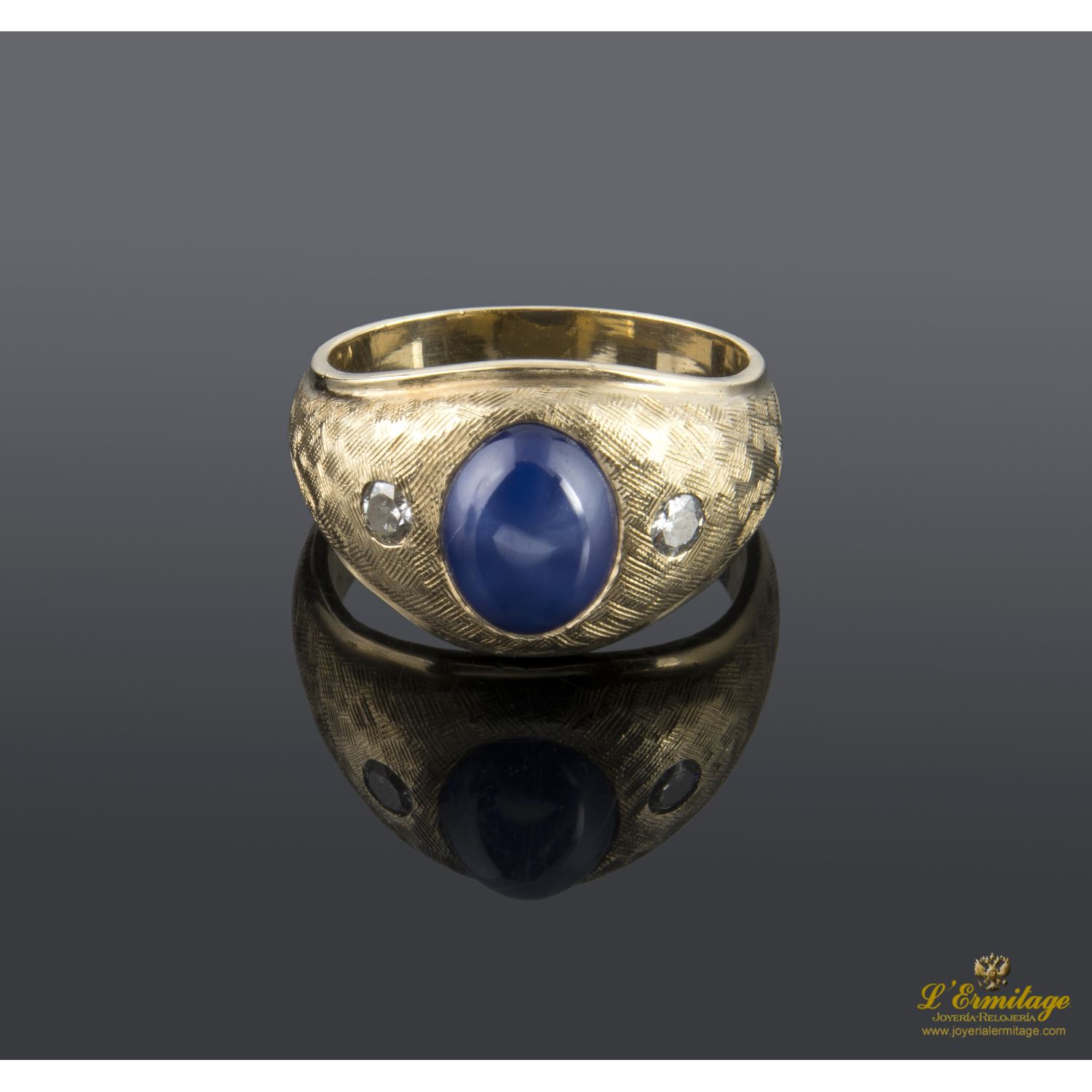 Sortija en oro amarillo con zafiro estrella y brillantes.