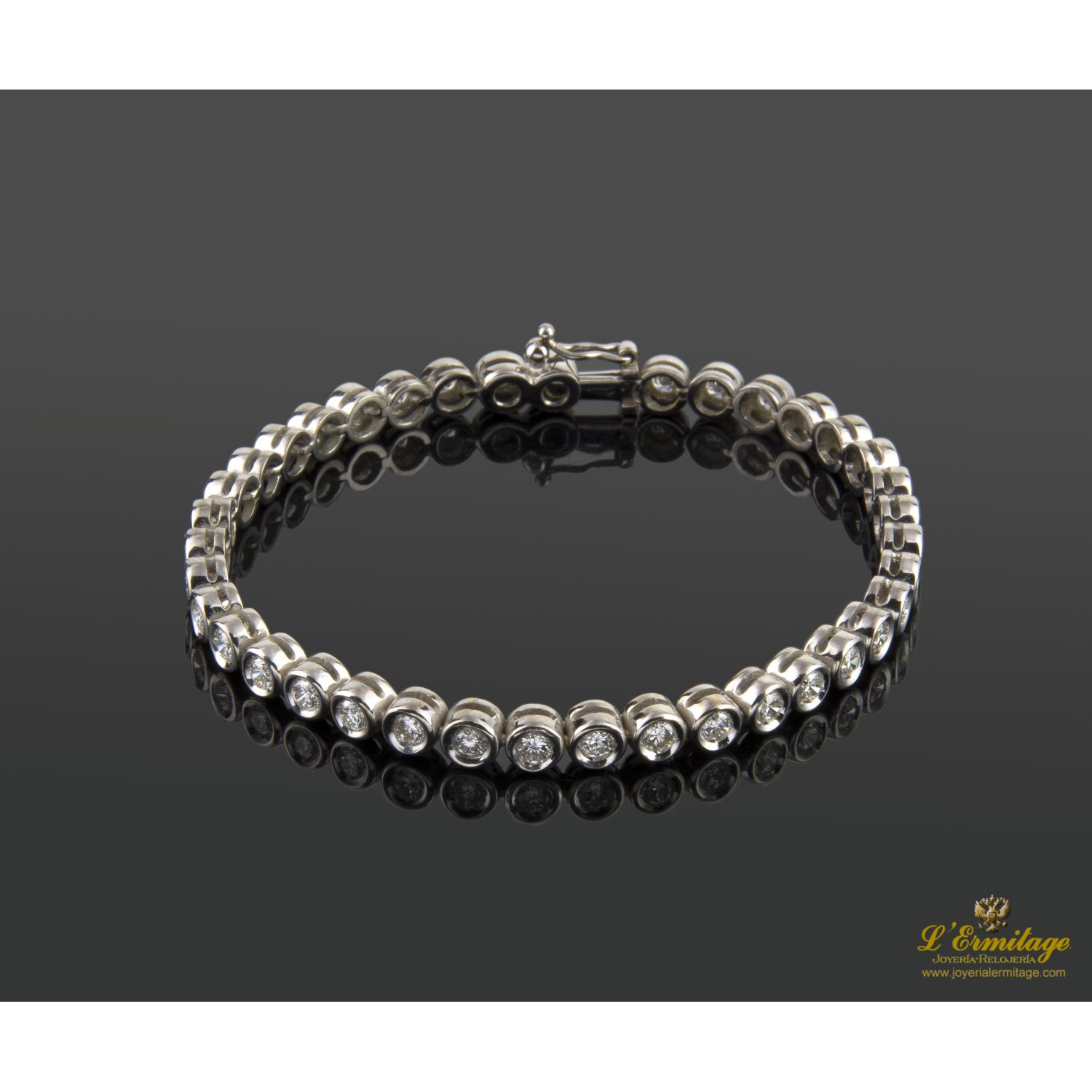 Pulsera riviere chatones oro blanco brillantes.