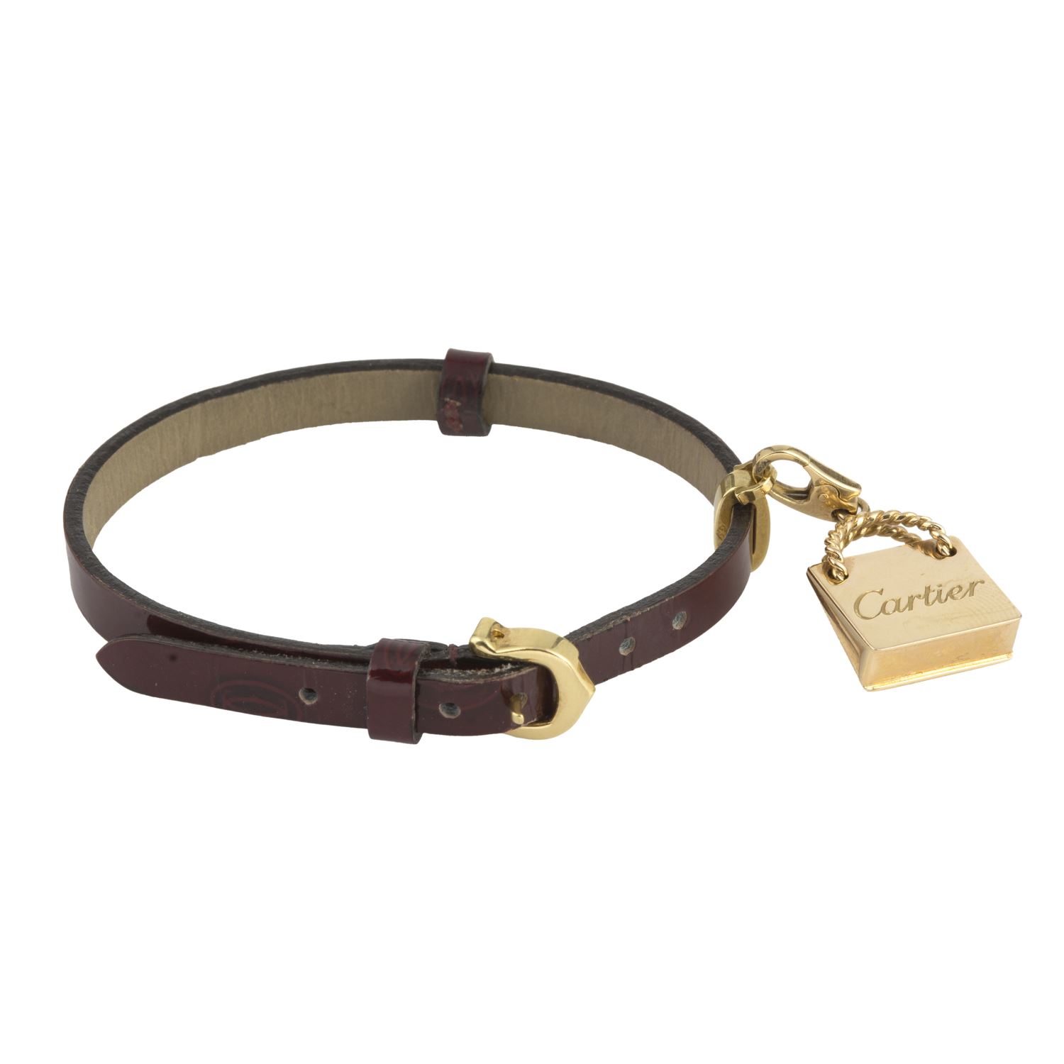 Pulsera cuero cartier con adorno de bolso en oro amarillo