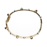 Pulsera rígida en oro amarillo con zafiros, rubíes, esmeraldas y brillantes.