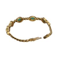 Pulsera en oro amarillo con esmeraldas y brillantes.