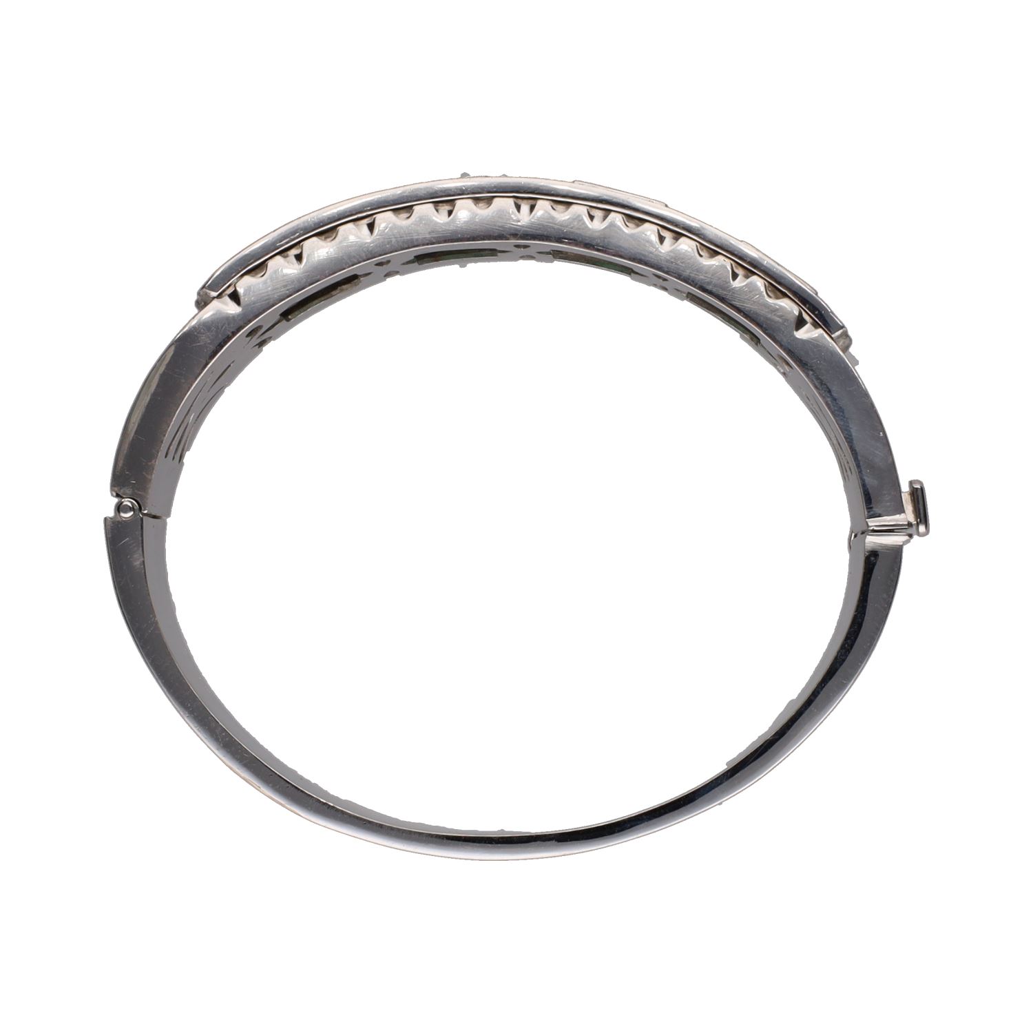Pulsera rígida en oro blanco con esmeraldas y brillantes.